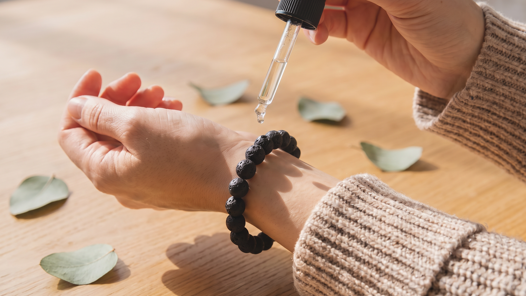 Woman adding essential oil to diffuser bracelet