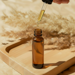Amber dropper bottle with oil being dispensed