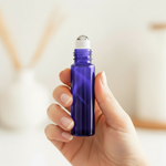 Dark blue/purple roller bottle held in hand