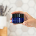 Hand holding smaller blue jar